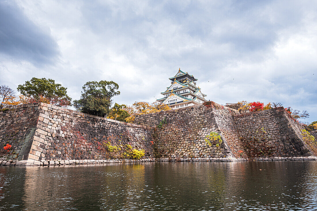 Steep castle moat walls and waters with autumnal colors in fall, Osaka, Hoshu, Japan, Asia