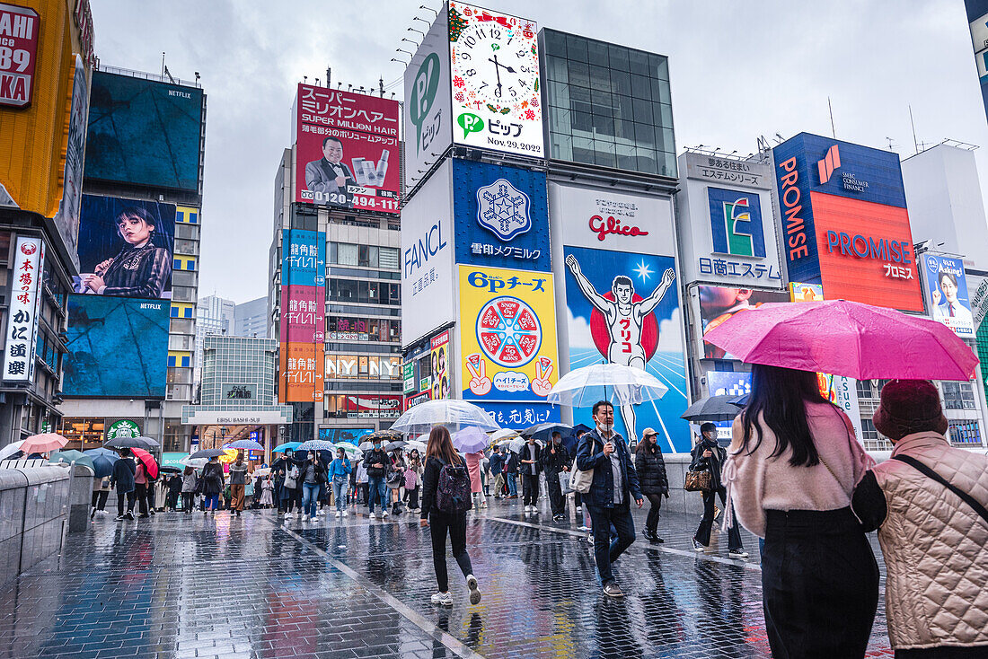 Famous Dotonbori Glico Sign, large vibrant advertisement on a rainy day, Dotonbori, Osaka, Honshu, Japan, Asia