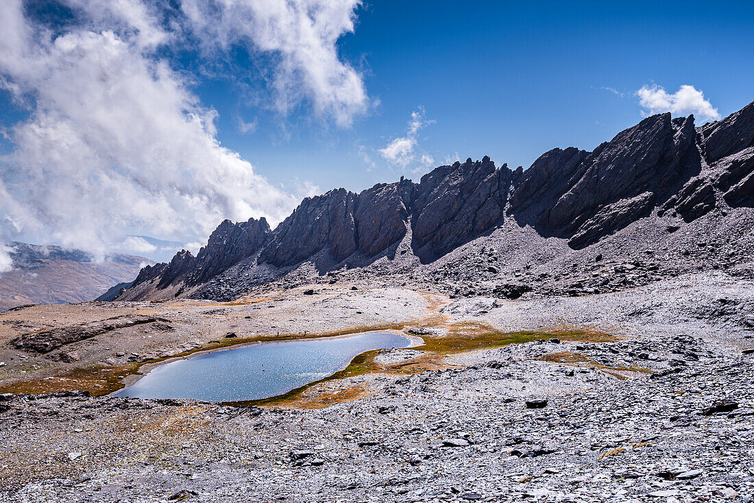 Dramatic rugged mountain range with a lake, Laguna del Rio Secco and Pico del Pulpito, Sierra Nevada, Andalusia, Spain, Europe