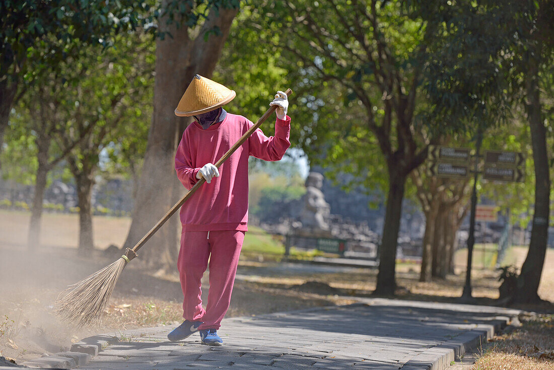 Sweeper in front of Sewu Temple Compound, 8th century Buddhist temple located at the north of Prambanan Temple Compounds, region of Yogyakarta, Java island, Indonesia, Southeast Asia, Asia