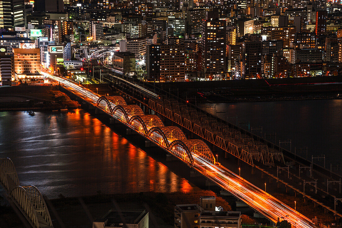 Traffic on bridges crossing the Yodo River and midnight night skyline of Osaka, Honshu, Japan, Asia