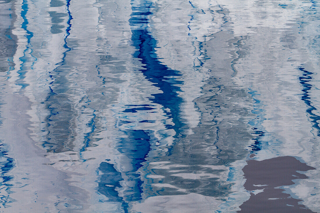 Reflections of icebergs in the calm water photographed from an expedition ship operating in Antarctica, Southern Ocean, Polar Regions