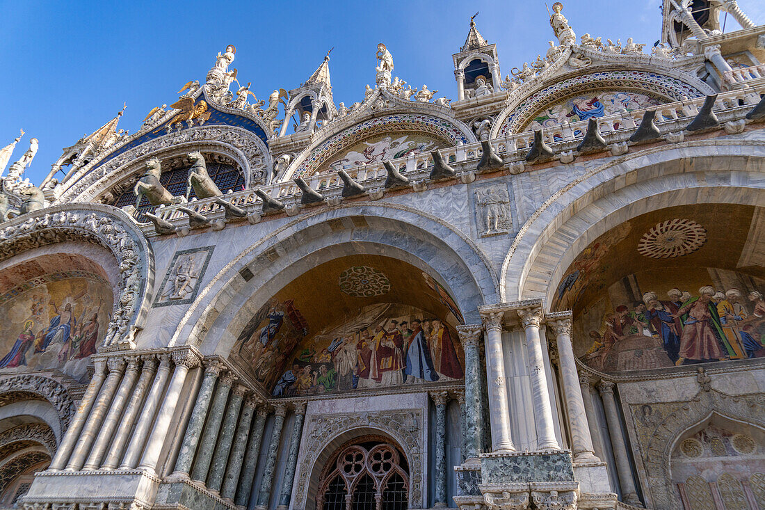 Mosaic art in a lunette on the facade of St. Mark's Basilica in Venice, Italy. This mosaic depicts the recovery of the relics of St. Mark from Egypt to Venice.