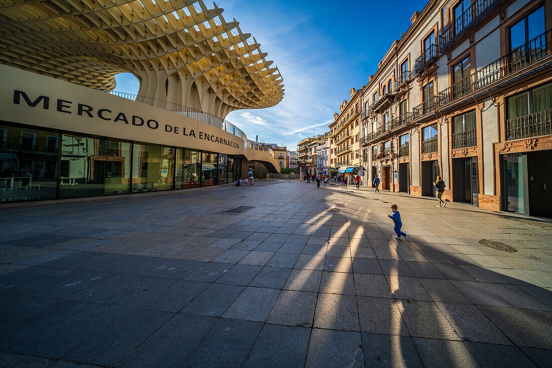 Seville, Spain, Jan 28 2021, A vibrant afternoon at Plaza de la Encarnacion in Sevilla, showcasing the distinctive architecture of Las Setas and the bustling market. People stroll under the clear blue sky.