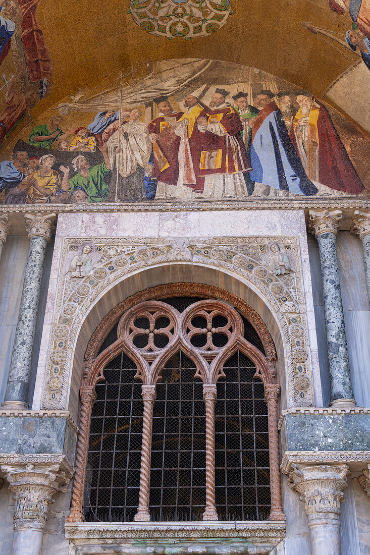 Mosaic art in a lunette on the facade of St. Mark's Basilica in Venice, Italy. This mosaic depicts the recovery of the relics of St. Mark from Egypt to Venice.