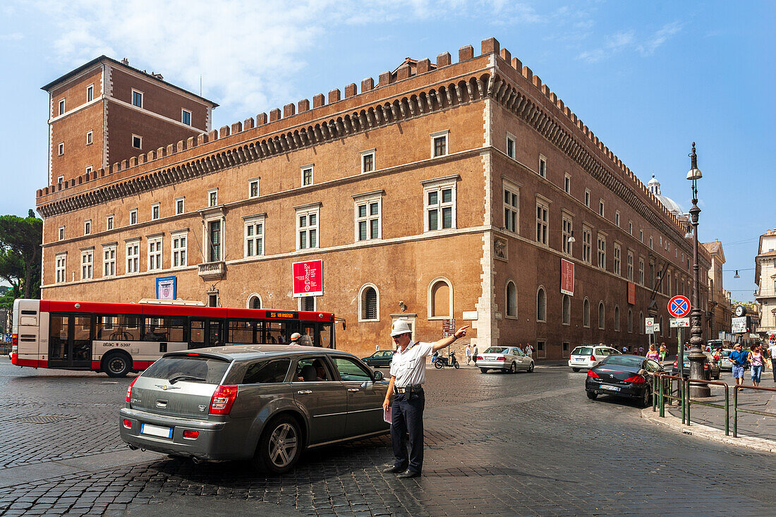 Rome, Italy, July 22 2017, A traffic officer directs vehicles near Palazzo Venezia, showcasing the lively atmosphere of Rome during the daytime.