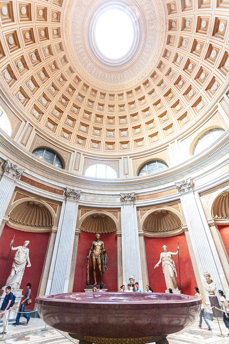 Rome, Italy, July 22 2017, Visitors admire the Round Room's intricate architecture, classical sculptures, and stunning dome in the Pius-Clementine Museum.