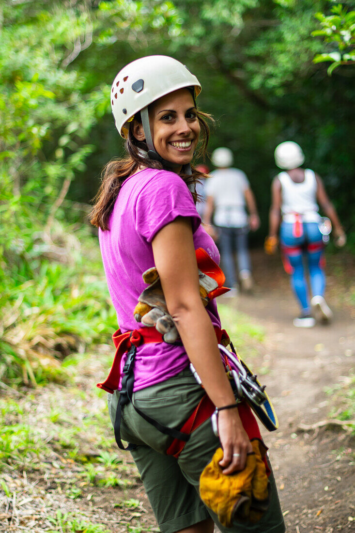 Young caucasian woman having fun during a Canopy tour in Costa Rica