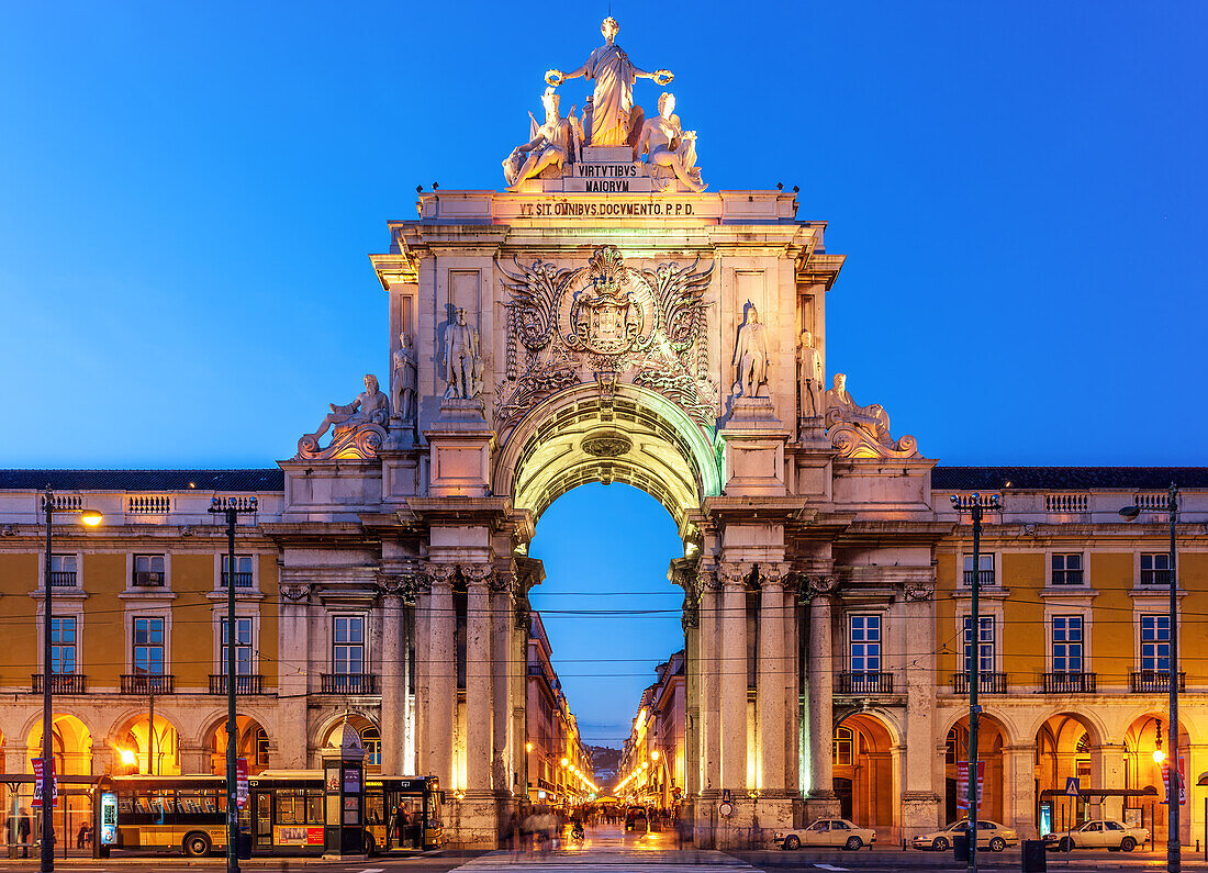 The Triumphal Arch stands majestically at Praça do Comércio, highlighting Lisbon's charm during twilight hours.