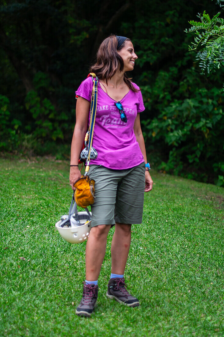 Young caucasian woman having fun during a Canopy tour in Costa Rica