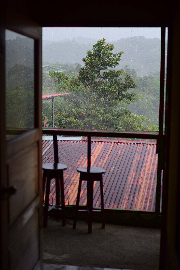 Heavy rains falling in Monteverde, seen through house window