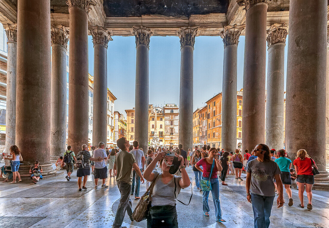 Rome, Italy, July 2017, A lively scene of tourists exploring the iconic Pantheon entrance, with the vibrant Piazza della Rotonda visible in the background, showcasing Rome’s rich architectural heritage and cultural attractions.