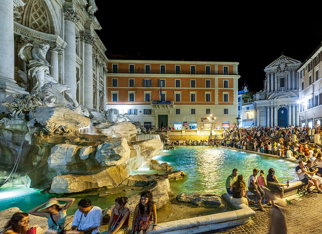 Rome, Italy, July 2017, Visitors fill the Trevi Fountain area, enjoying the magical ambiance of Rome at night.