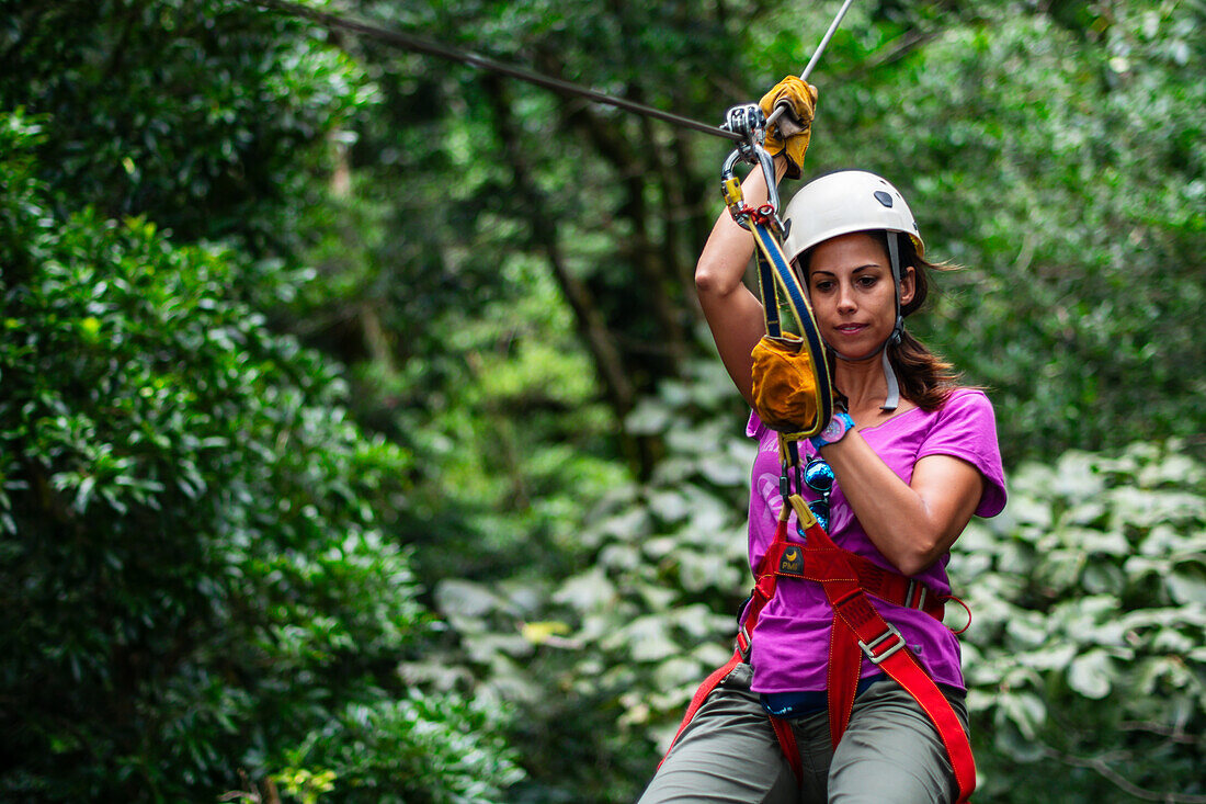 Young caucasian woman having fun during a Canopy tour in Costa Rica