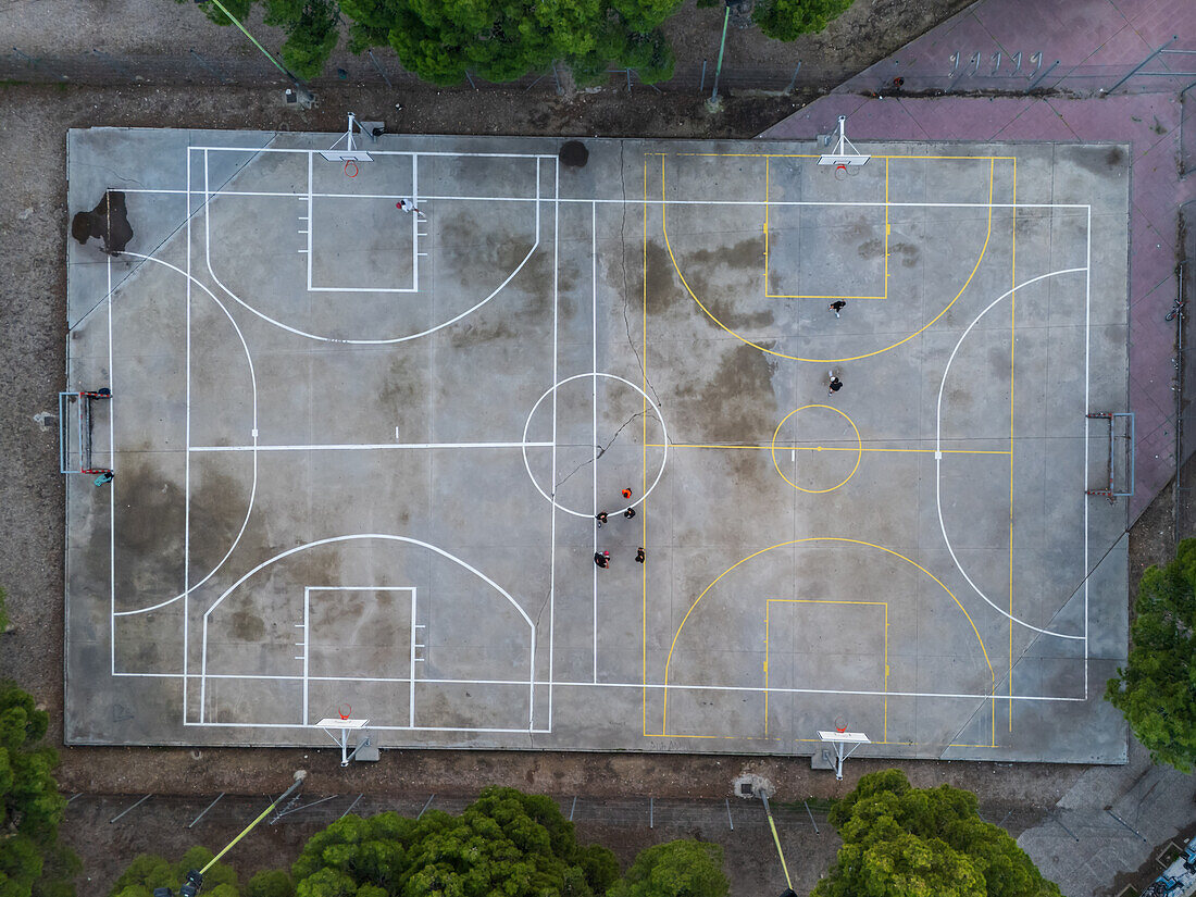 Basketball and soccer exterior courts among trees in city park, Zaragoza, Spain