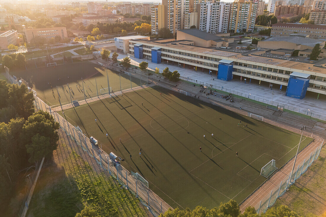 Aerial view of amateur soccer match at sunset