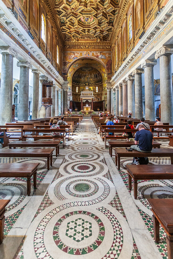 Rome, Italy, July 2017, The interior of Santa Maria in Trastevere basilica showcases its ornate architecture and rich history, drawing visitors in awe.