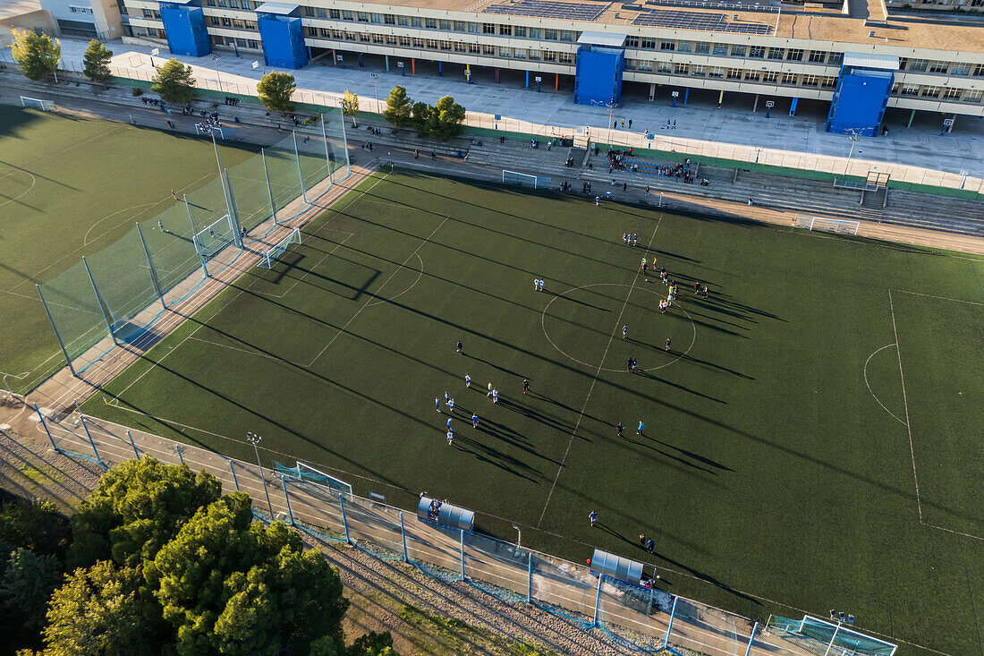 Aerial view of amateur soccer match at sunset