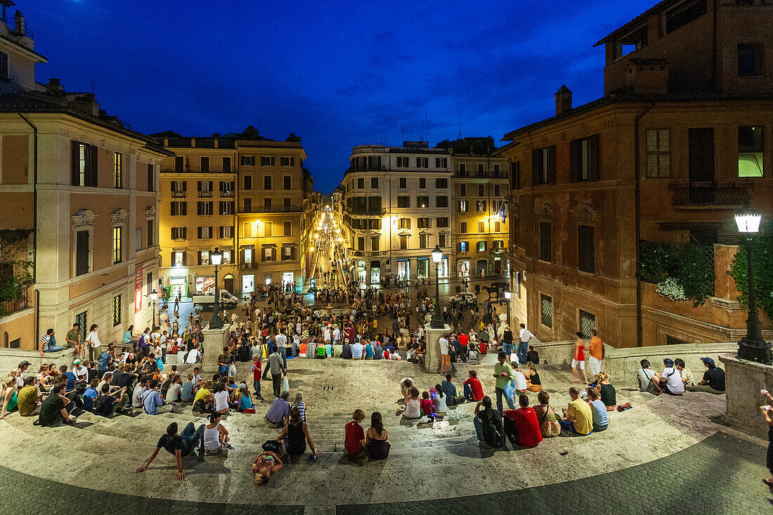 Rome, Italy, July 22 2017, Visitors gather on the Spanish Steps in Rome as the sun sets, creating a vibrant and lively atmosphere filled with chatter and excitement.