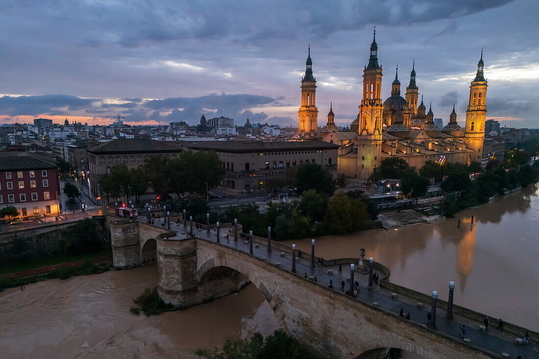 Aerial view of an illuminated El Pilar Basilica Cathedral and the Ebro River at night, Zaragoza, Spain