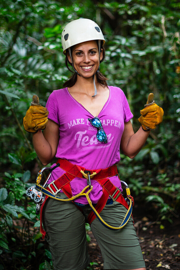 Young caucasian woman having fun during a Canopy tour in Costa Rica