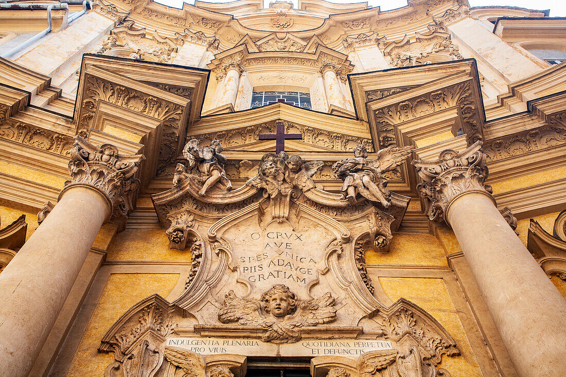 Admire the intricate rococo detailing of the Maddalena Church facade, showcasing artistry and architectural beauty in Rome.