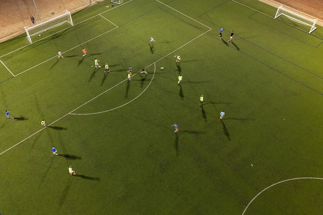 Aerial view of a training in a soccer field at night