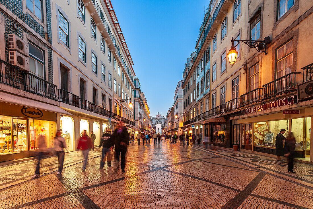 Lisbon, Portugal, March 1 2007, Pedestrians enjoy a leisurely walk along Augusta Street as dusk falls over Lisbon's bustling Baixa district, filled with charming shops.