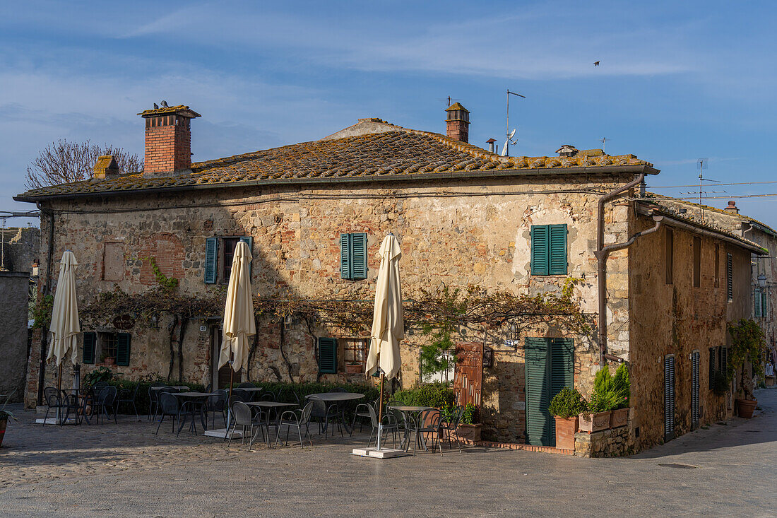 A restaurant on the Piazza Roma in the medieval walled town of Monteriggioni, Sienna Province, Italy.