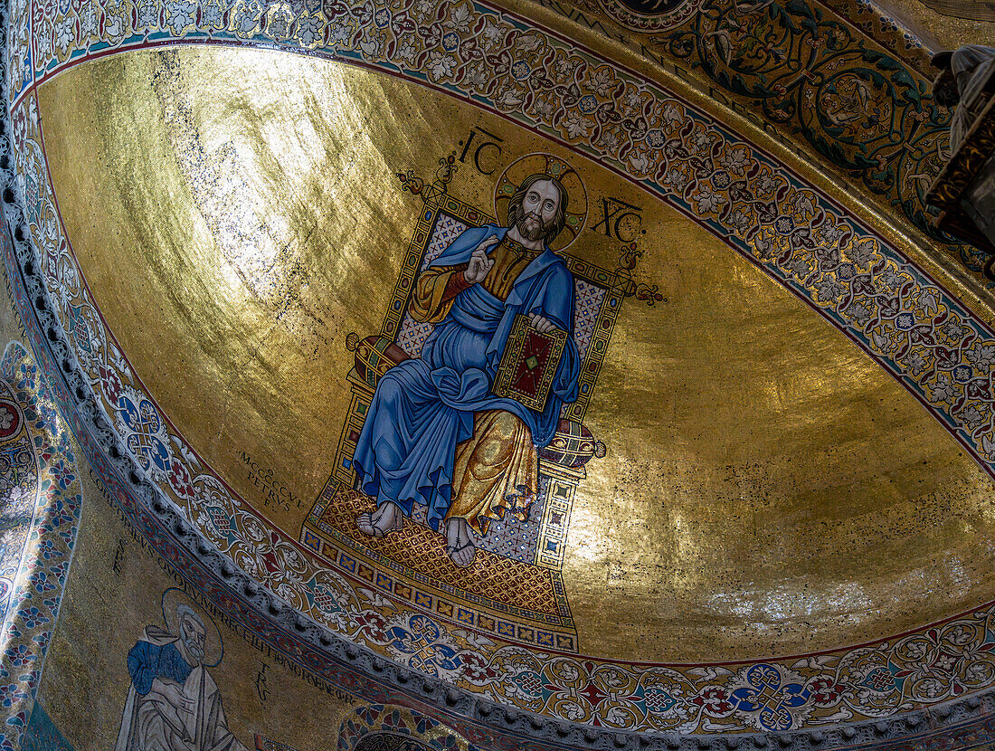 A gold mosaic of Christ on a throne in the cupola of the main apse in St. Mark's Basilica, Venice, Italy.