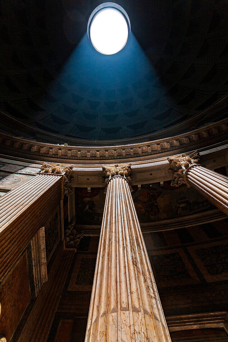 Rome, Italy, July 2017, A beam of sunlight pierces the Pantheon dome, highlighting the majestic Corinthian columns in Rome's historic architecture.