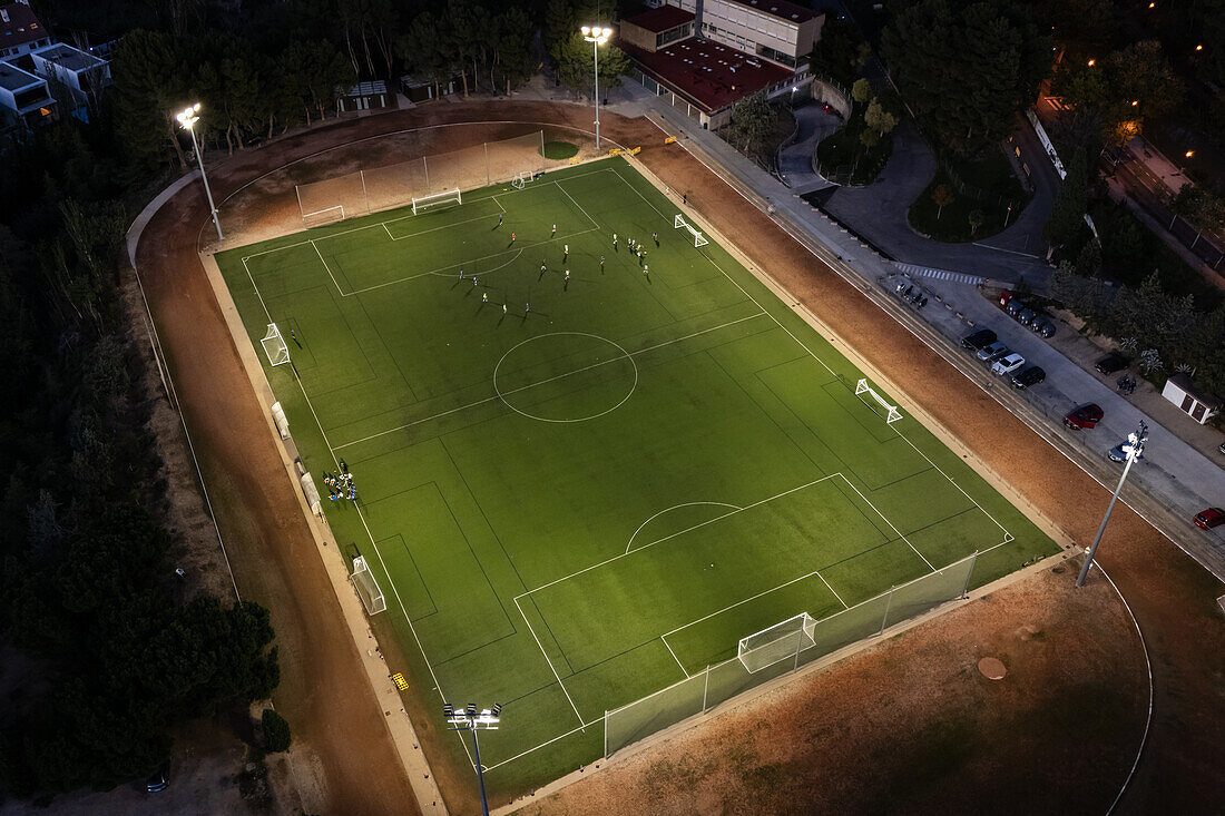 Aerial view of a training in a soccer field at night