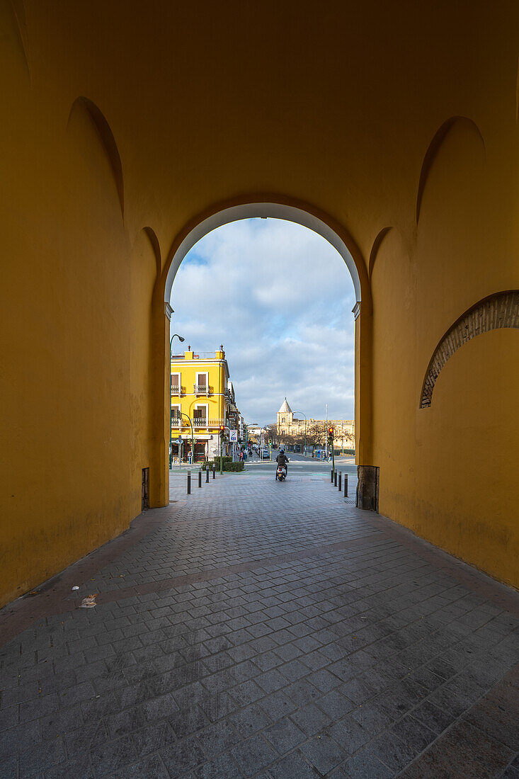 View through Arco de la Macarena towards Andalusian Parliament in Seville, Spain.