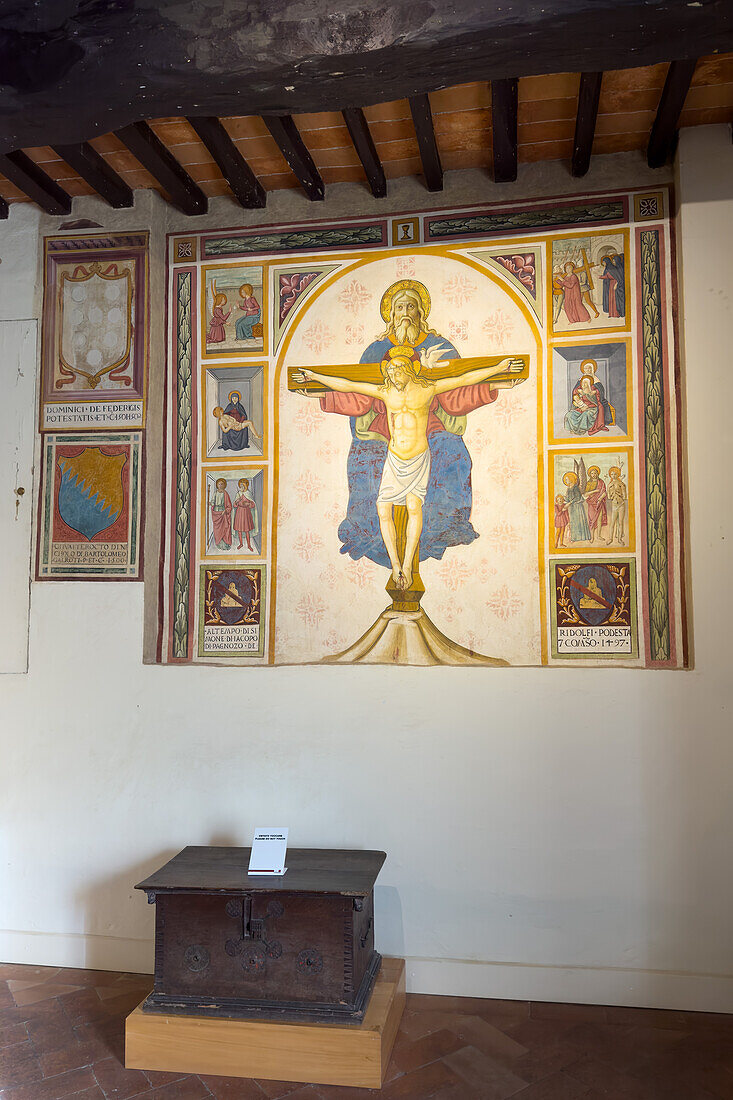 The Podesta Chapel of the Palazzo Comunale or city hall of the medieval city of San Gimignano, Italy. Shown are The Trinity and Stories of Christ by Pier Francesco Florentino, circa 1497, and a wood and metal coffer from the late 15th Century.