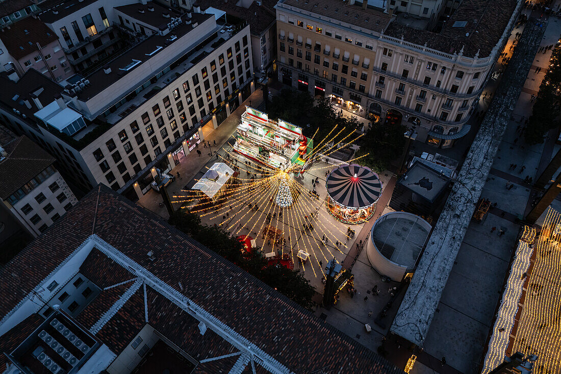 Aerial view of Christmas decoration and entertainment illuminated at night in El Pilar Square, Zaragoza, Spain