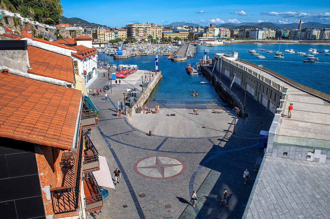 Picturesque houses, Fishing boats and sport fishing boats to recreational boat fishing are moored in the harbor of Donostia San Sebastian.