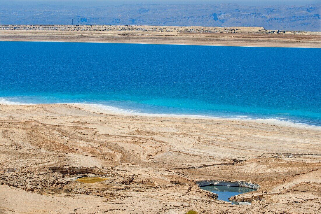 Salt on the beach of the dead sea in Israel border with Jordan.