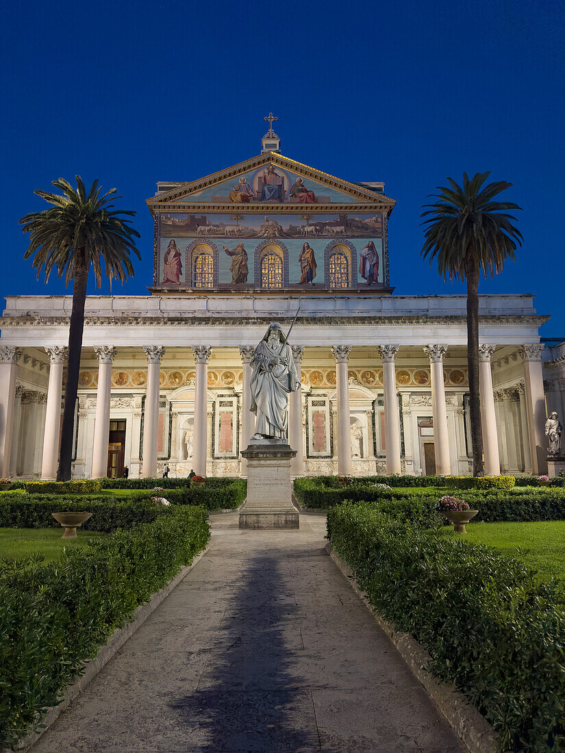 The statue of St. Paul and facade of the Basilica of St. Paul Outside the Walls, Rome, Italy.