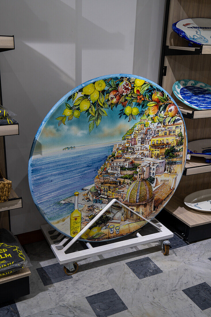 A ceramic tabletop with a scene of the Amalfi Coast for sale in the Campaniadamare shop in Sorrento, Italy.