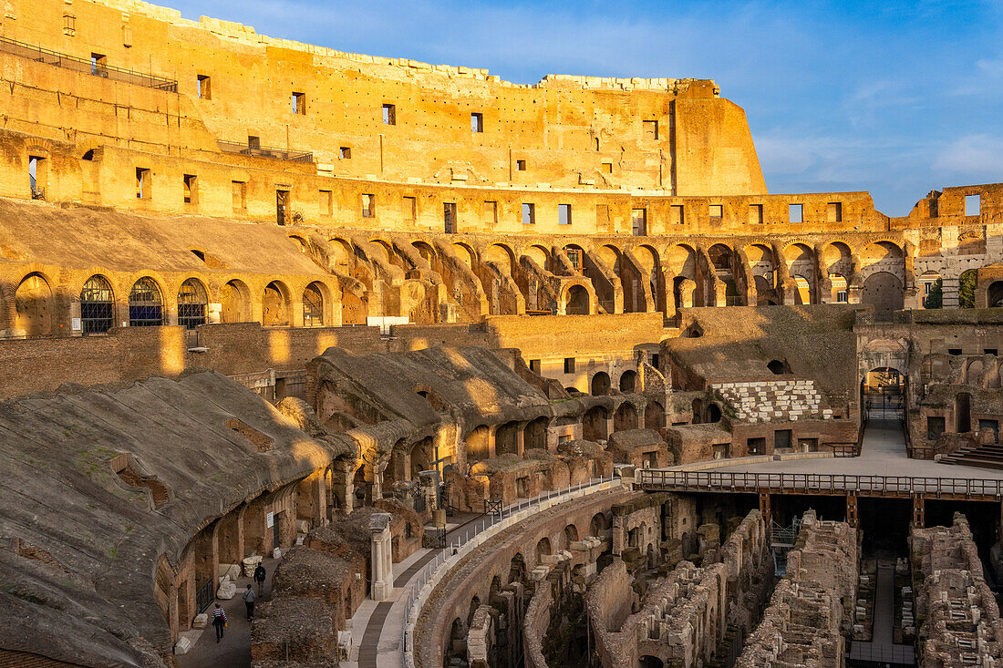 Interior of the Roman Colosseum or Flavian Amphitheater with golden sunset light in Rome, Italy. The tunnels under the floor of the arena were called hypogeum.