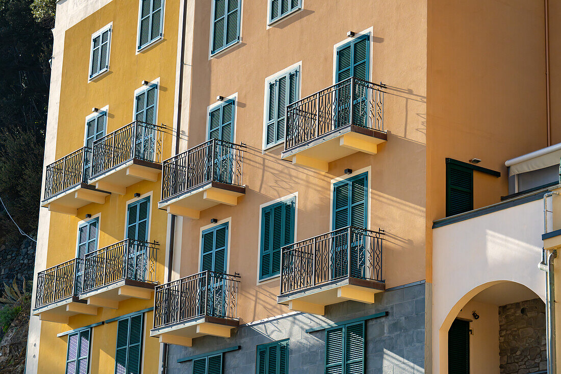 Balconies and shutters on colorful buildings in Monterosso al Mare, Cinque Terre, Italy.