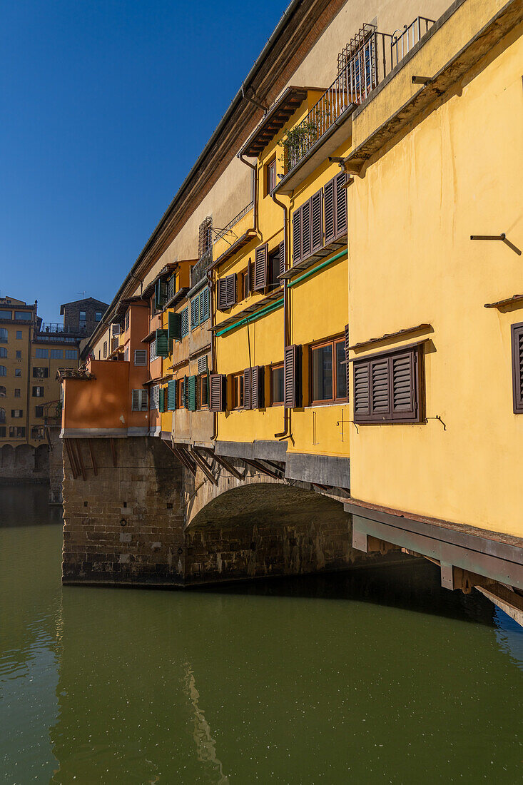 The Ponte Vecchio, a medieval stone arch bridge over the Arno in Florence, Italy.