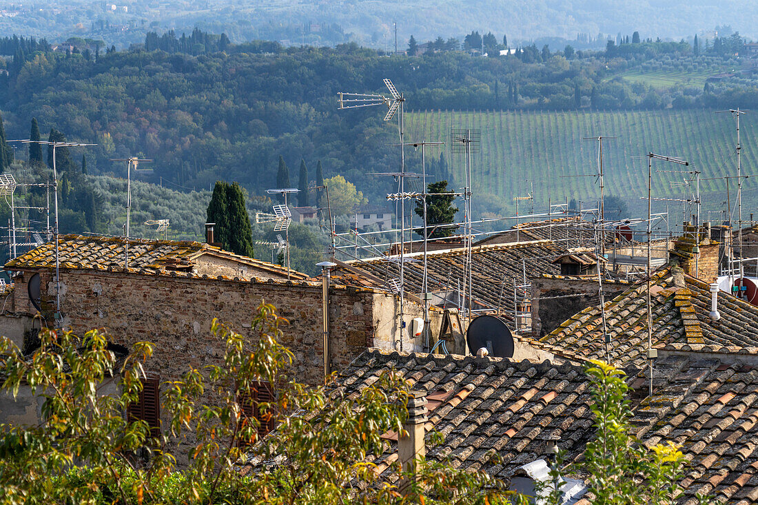 Contrast - television antennas on the clay tile roofs of medieval buildings in San Gimignano, Italy.