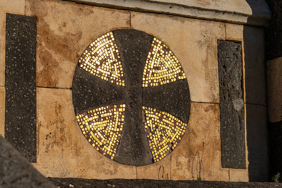 An Orthodox cross with gold mosaic tiles on the facade of the Cathedral of St. Andrew, the Amalfi Duomo. Italy.