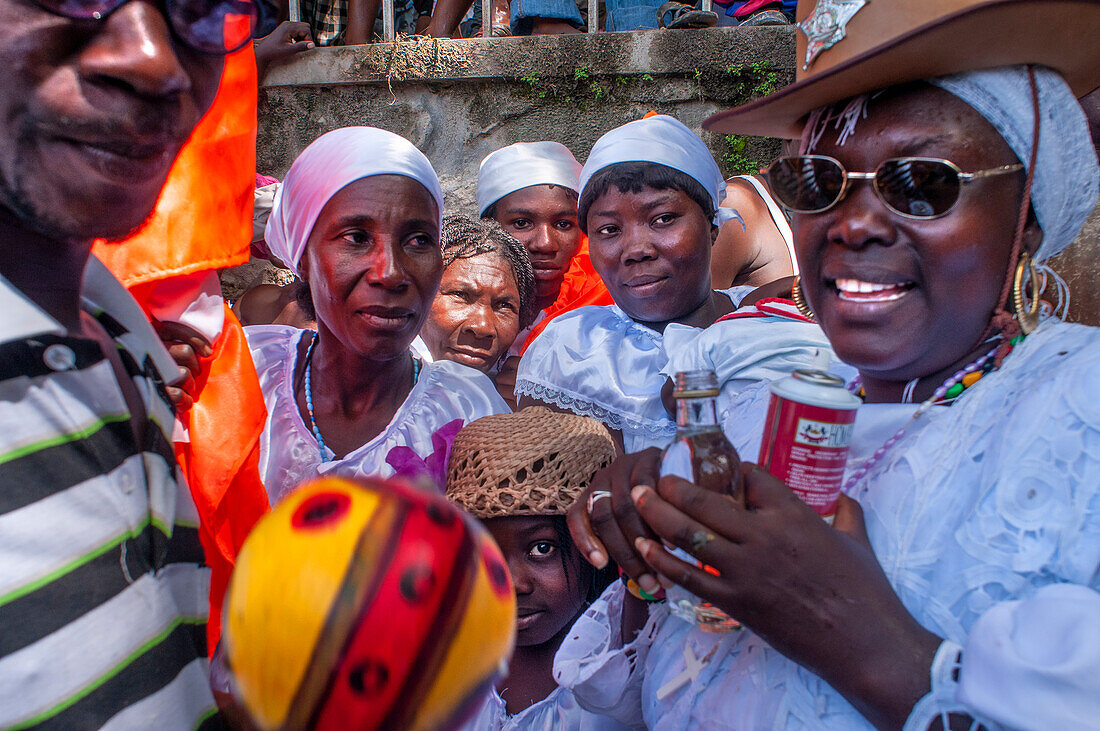 Haiti Voodoo Festival in Saut d'Eau, in Saut d'Eau, Ville Bonheur, Haiti. Thousands of both Vodou and Catholic followers gathered under the Saut d'Eau waterfall in Haiti. The pilgrimage, made by Voodou practitioners and Catholics alike, originated with the sighting of the likeness of the Virgin Mary on a palm leaf close to the falls half a century ago. Catholism and Voodou practices are forever intertwined in its Haitian form. The appearance of a rainbow beneath the falls is said indicate that Danbala - the great lord of the waterfall - and Ayida Wedo - the rainbow - are making love. Fertility