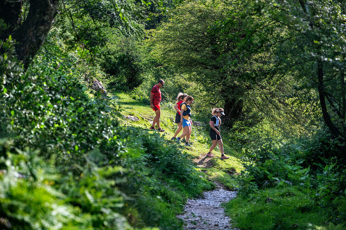 People running on the way to the San Adrián tunnel on the Aizkorri mountain range at the Basque Country, Goierri, Basque Highlands Basque Country, Euskadi Spain.