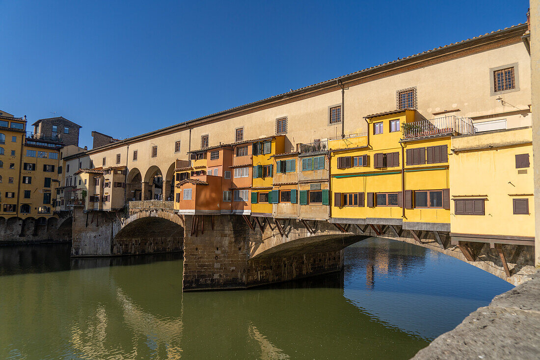 The Ponte Vecchio, a medieval stone arch bridge over the Arno in Florence, Italy.