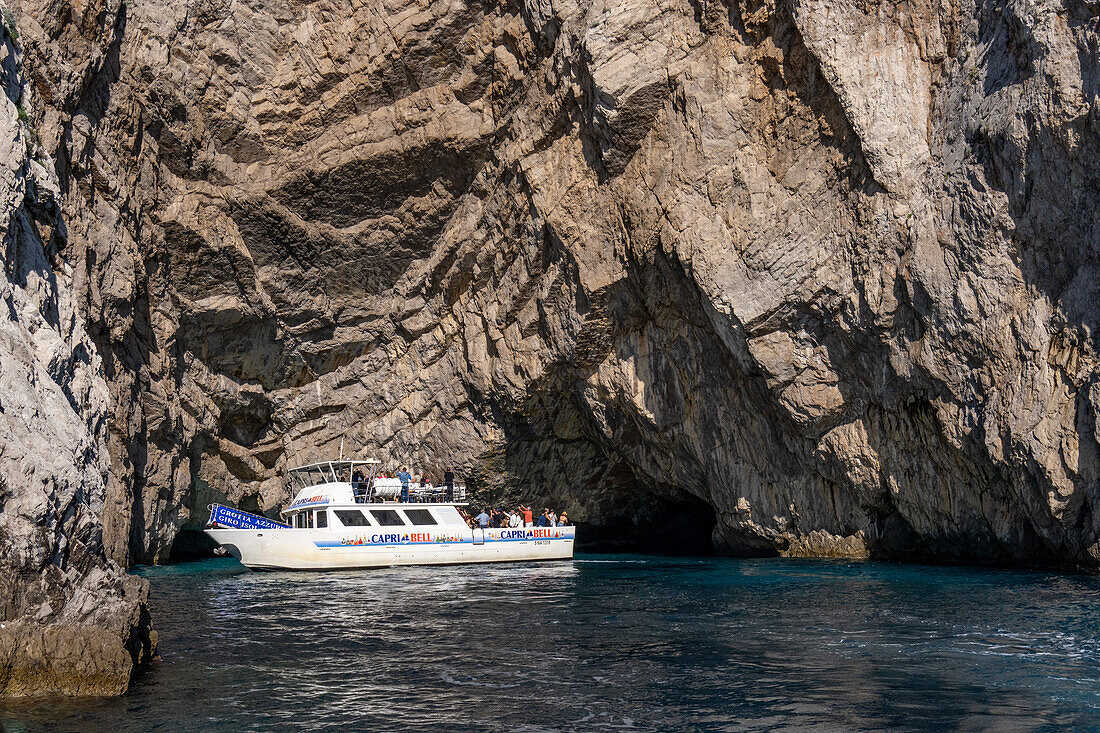 A tour boat with passengers at the Green Grotto on the island of Capri, Italy.