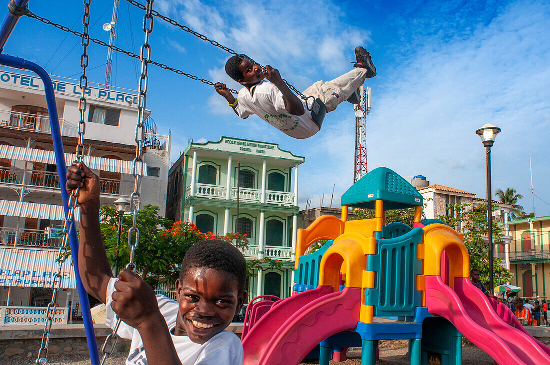 Chindren playing in the children's playground in Jacmel town square in Jacmel city center, Haiti