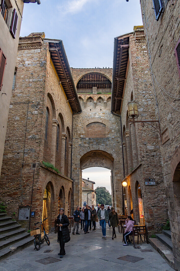 The Via San Giovanna passes through the Porta San Giovanni into the medieval city of San Gimignano, Italy.